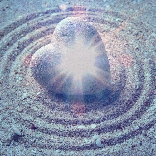 mystical heart Grey Japanese Zen stone in shape of heart on sand